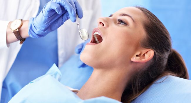 Patient getting a dental exam looking for cavities